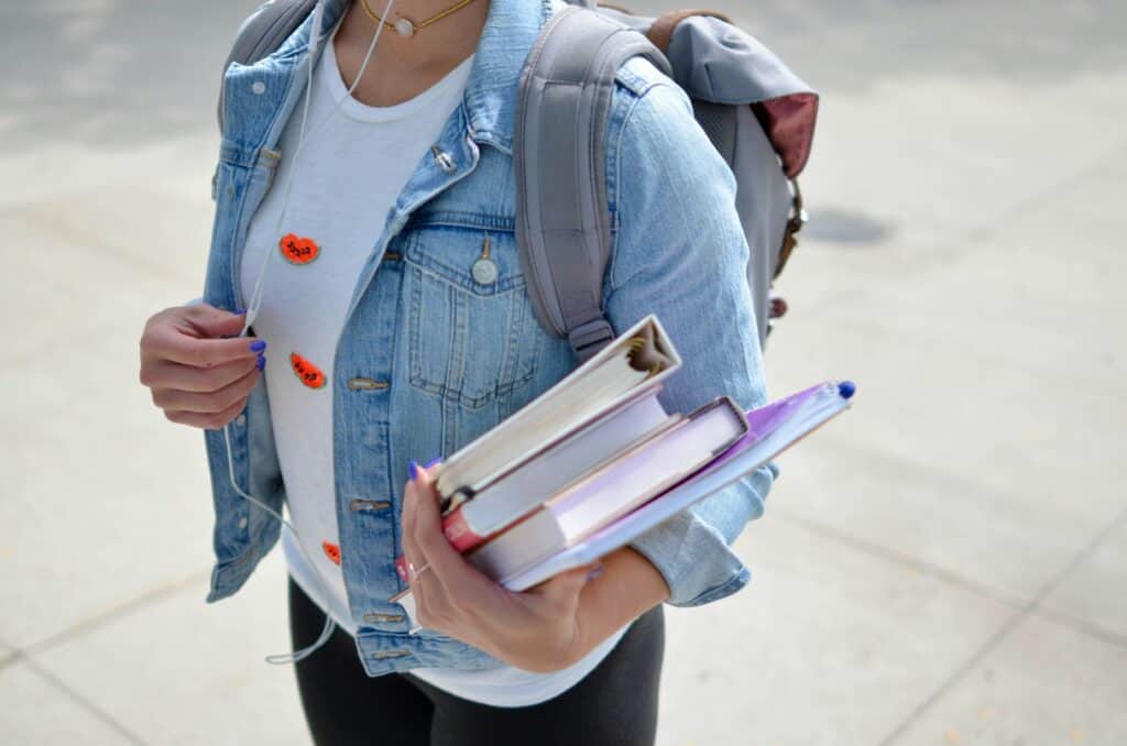 A student carries books at university