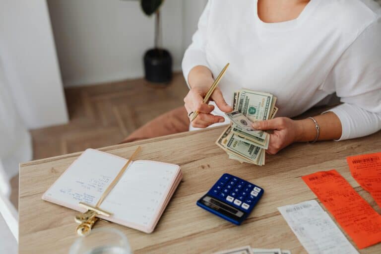 woman computing with receipts